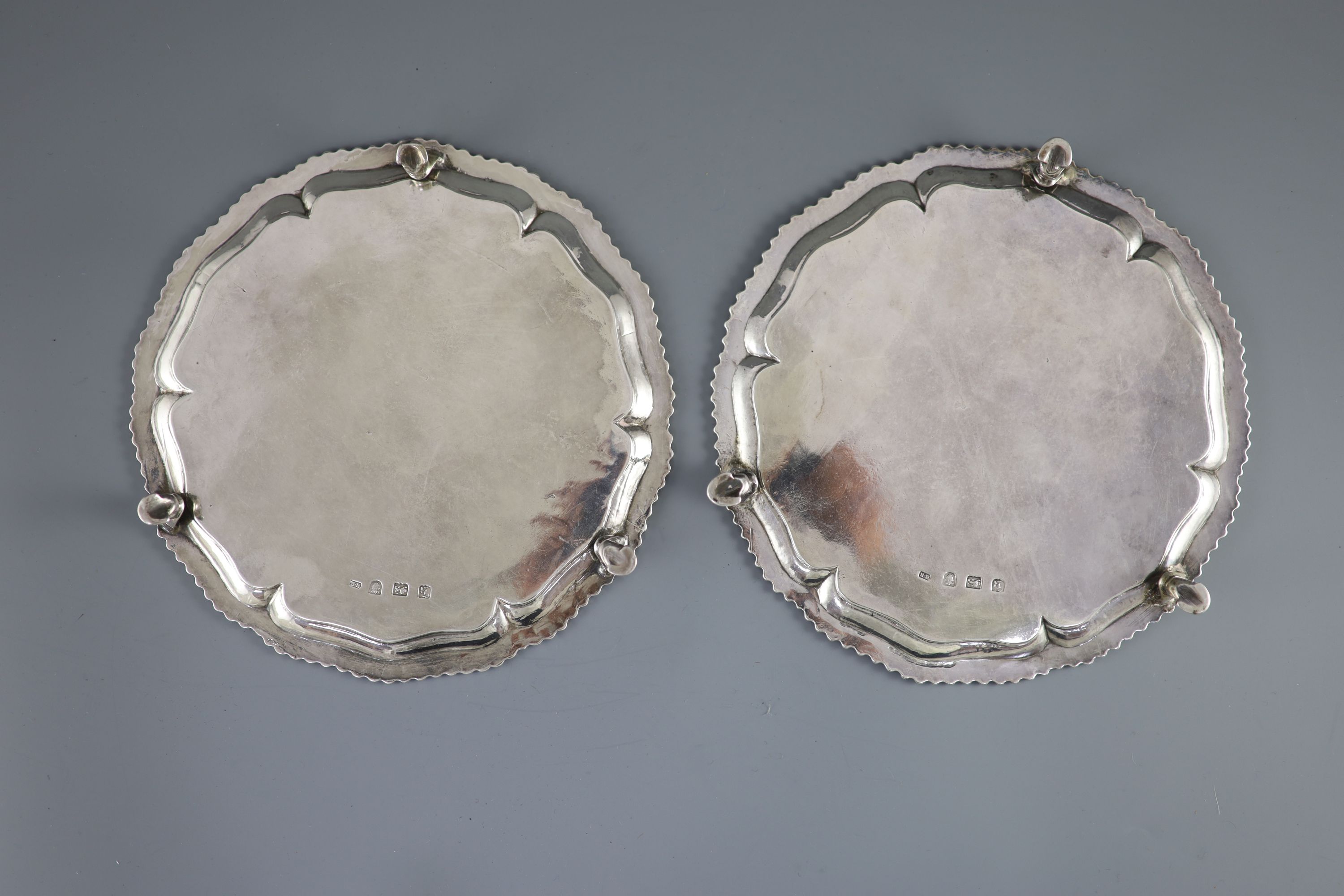 A pair of early George III silver salvers by Richard Rugg,